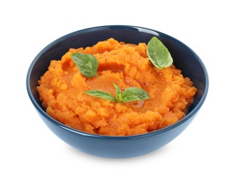 Photo of Tasty mashed sweet potato with basil in bowl isolated on white