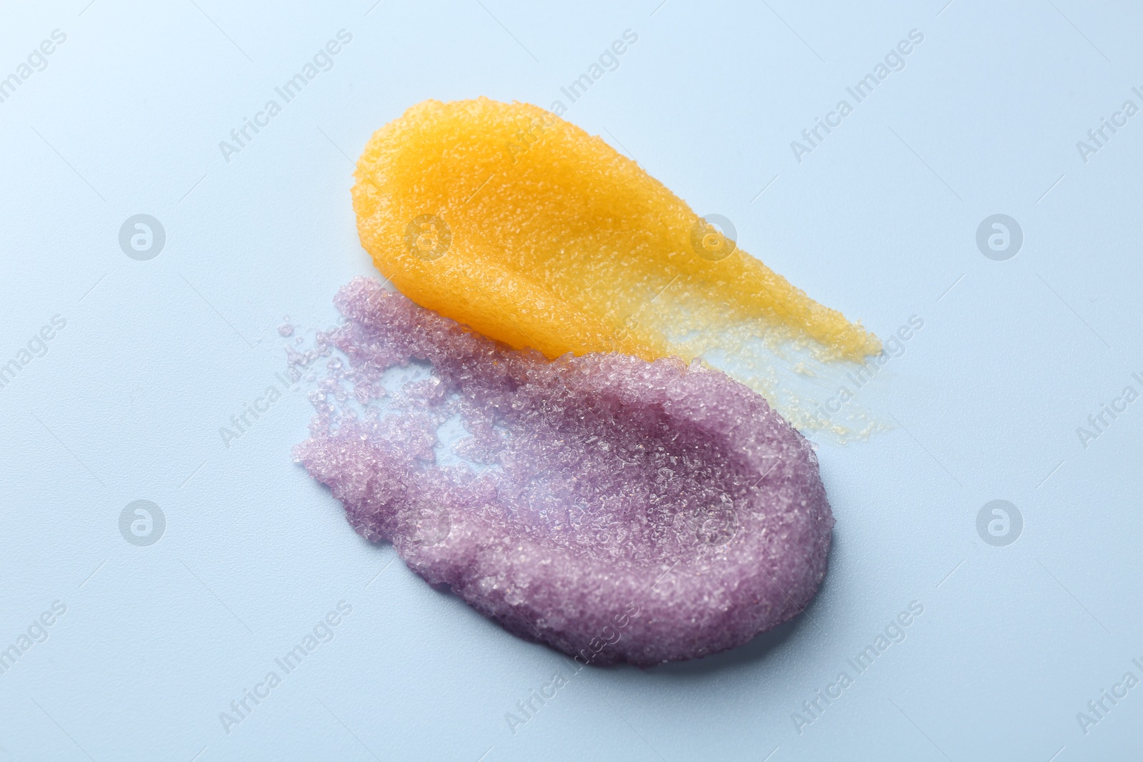 Photo of Smears of body scrubs on light background, closeup