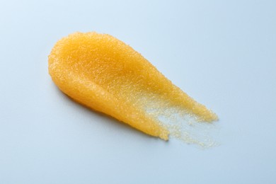 Photo of Smear of body scrub on light background, closeup