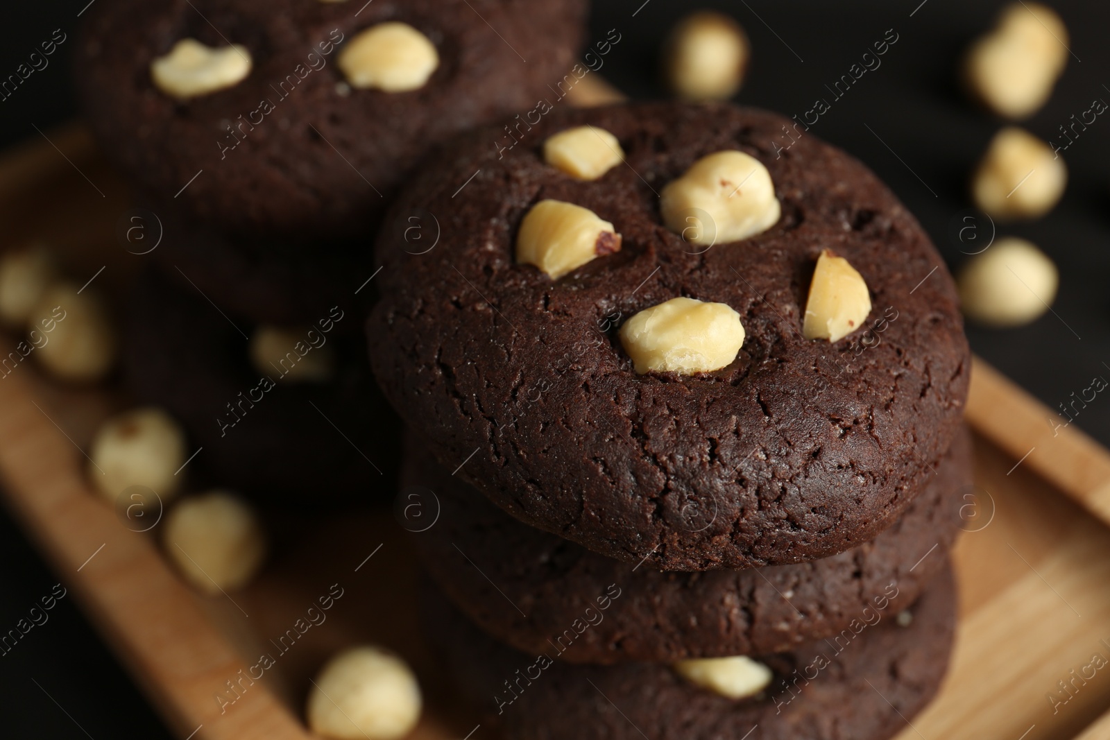 Photo of Delicious chocolate cookies with hazelnuts on table, closeup