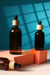 Photo of Bottles of cosmetic product on color background