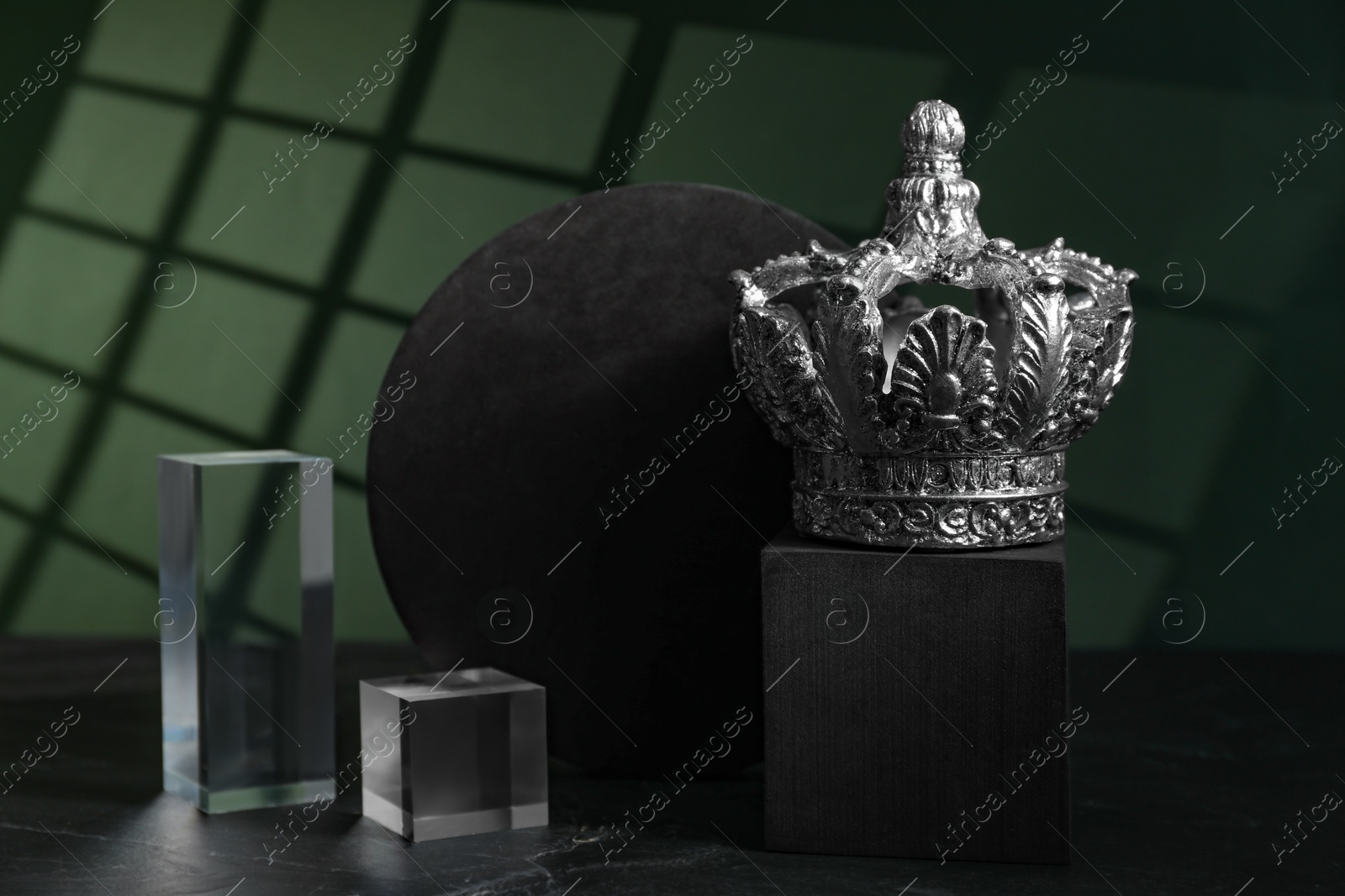 Photo of Stylish silver crown and geometric shapes on color background