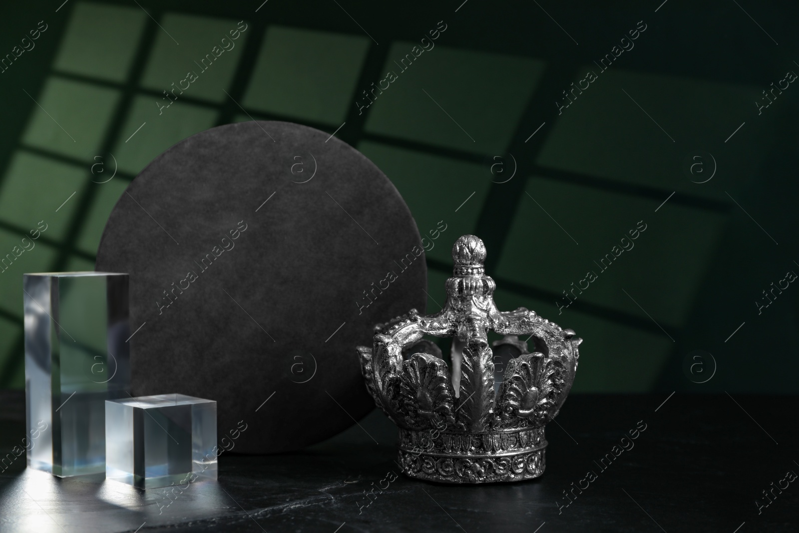 Photo of Stylish silver crown and geometric shapes on color background