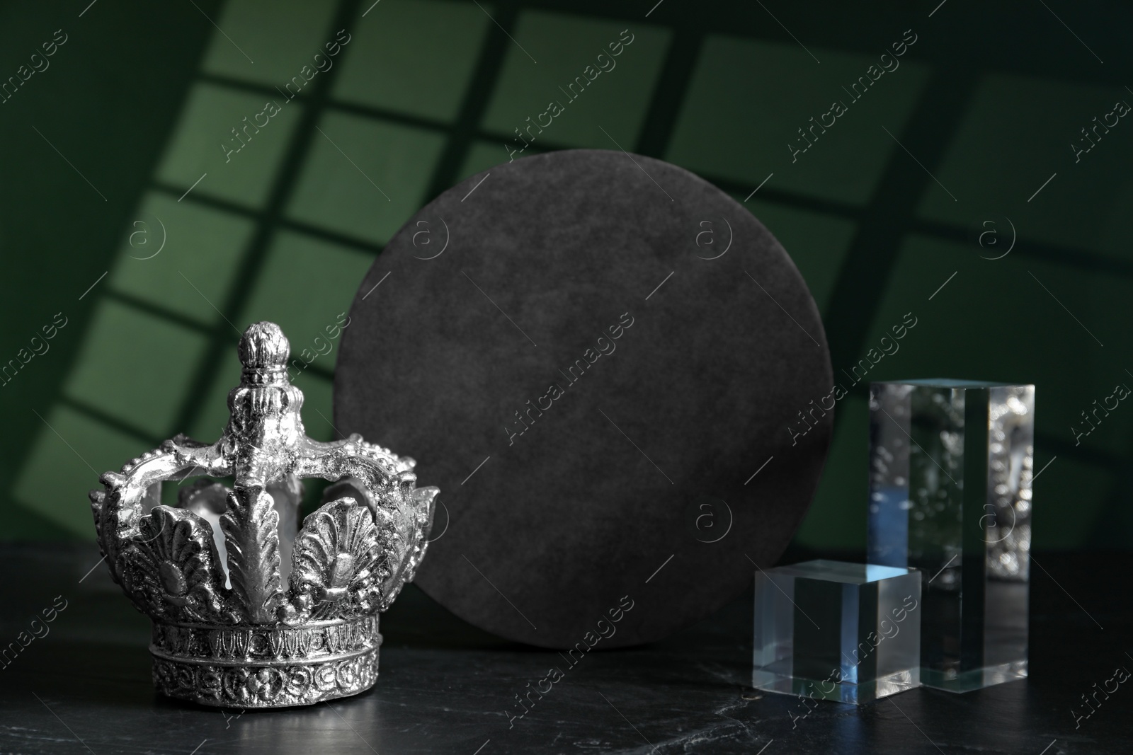 Photo of Stylish silver crown and geometric shapes on color background