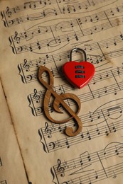 Photo of Clef figure and heart shaped padlock on musical notes