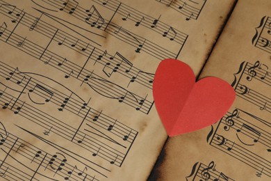 Photo of Paper heart on musical note sheets, closeup