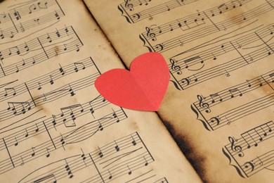 Paper heart on musical note sheets, closeup