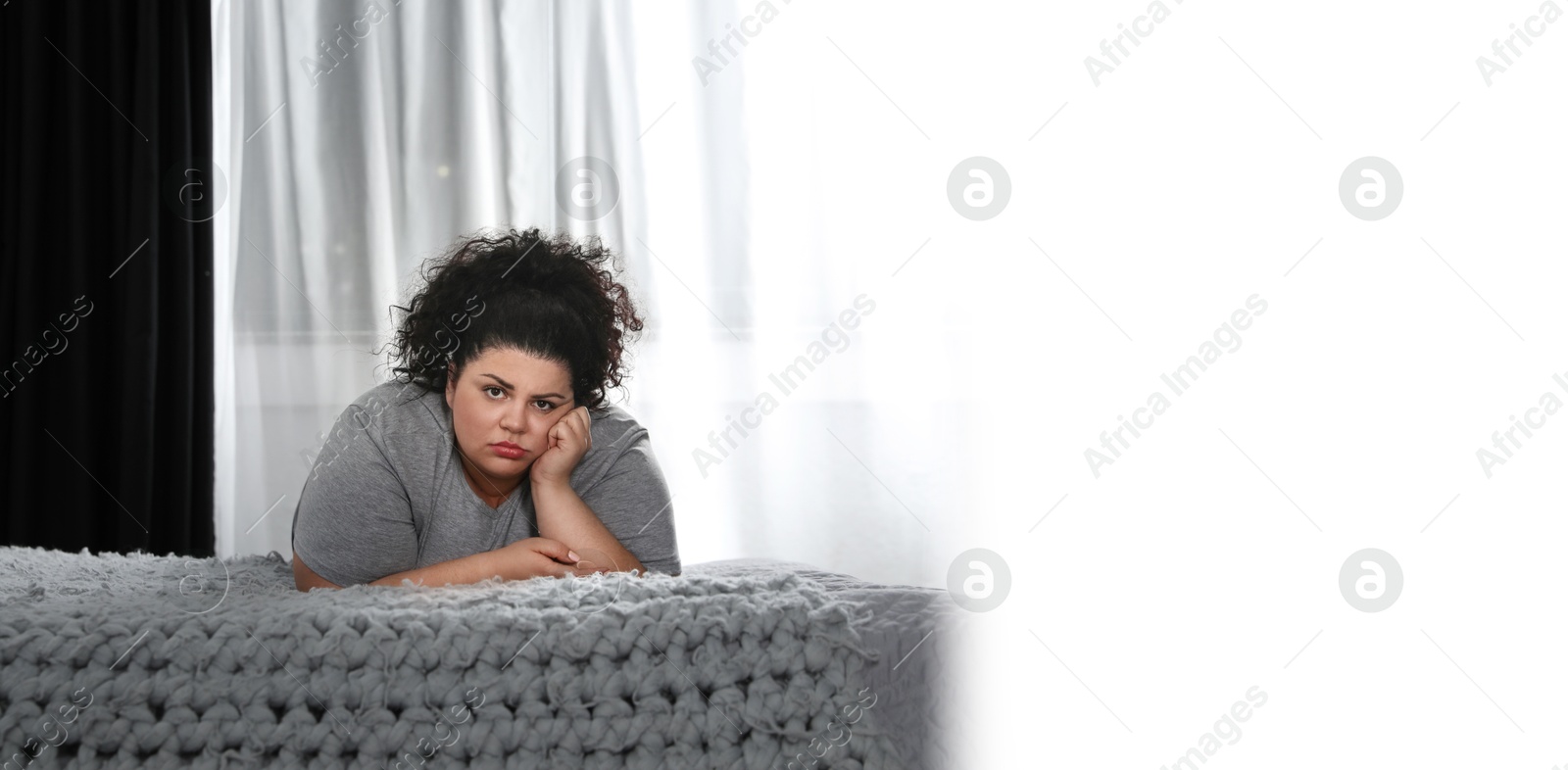 Image of Depressed overweight woman on bed at home. Banner design with space for text