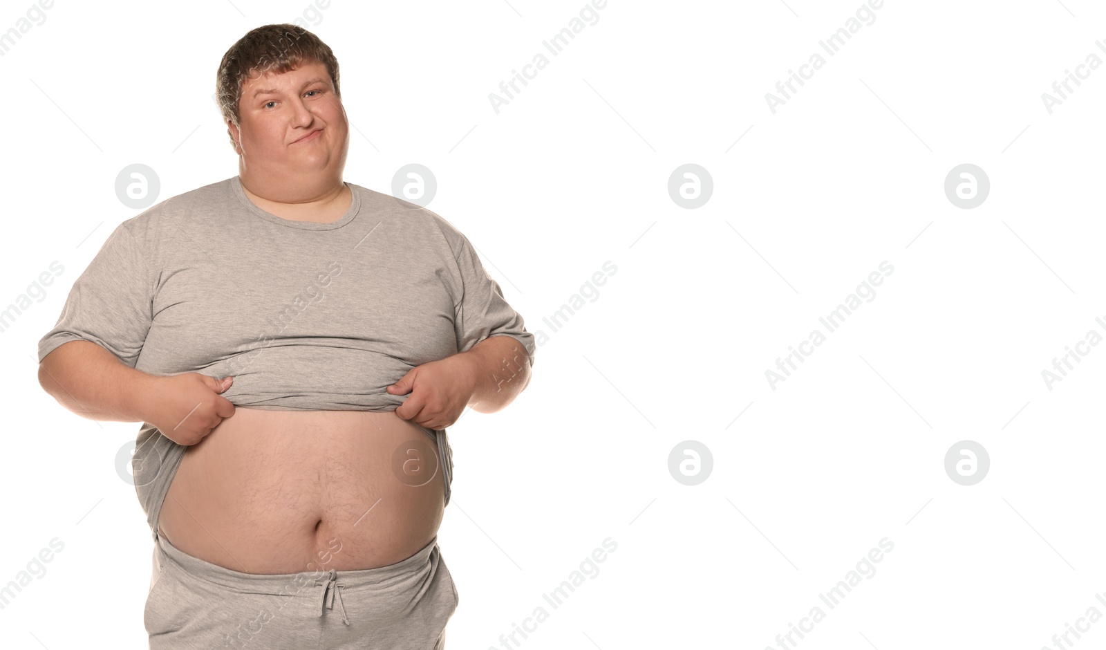 Image of Unhappy overweight man showing his belly on white background