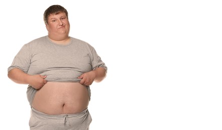 Unhappy overweight man showing his belly on white background