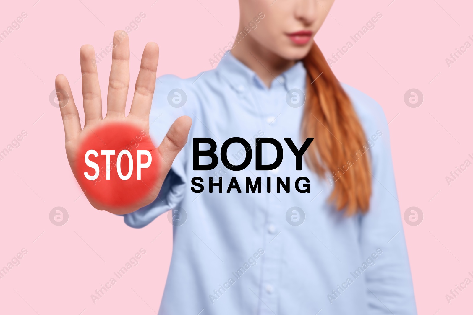 Image of Stop body shaming. Woman showing palm with red warning sign on pink background, closeup