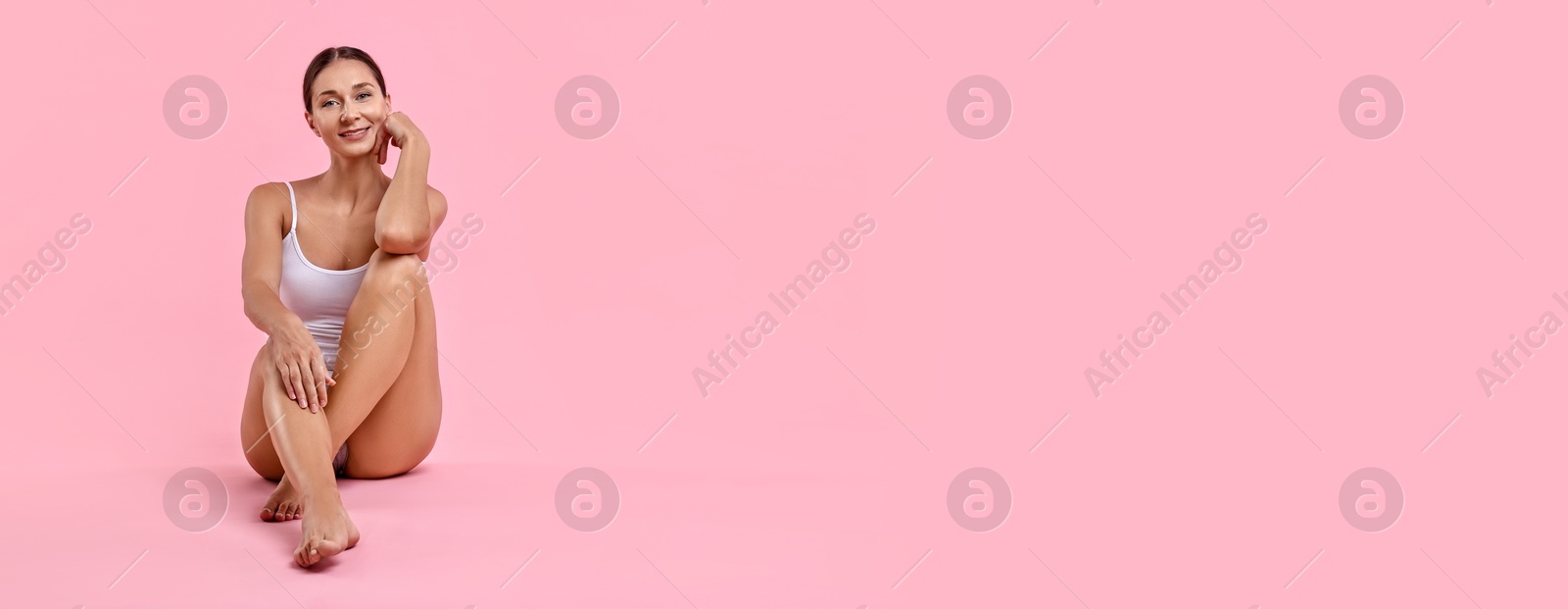 Image of Beautiful woman with smooth skin on pink background. Banner design with space for text. Body care