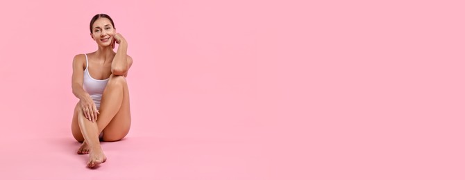 Beautiful woman with smooth skin on pink background. Banner design with space for text. Body care