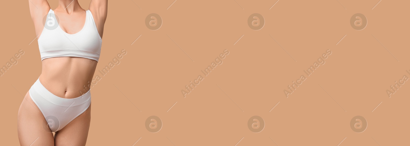 Image of Woman with smooth skin in underwear on dark beige background, closeup. Banner design with space for text. Body care