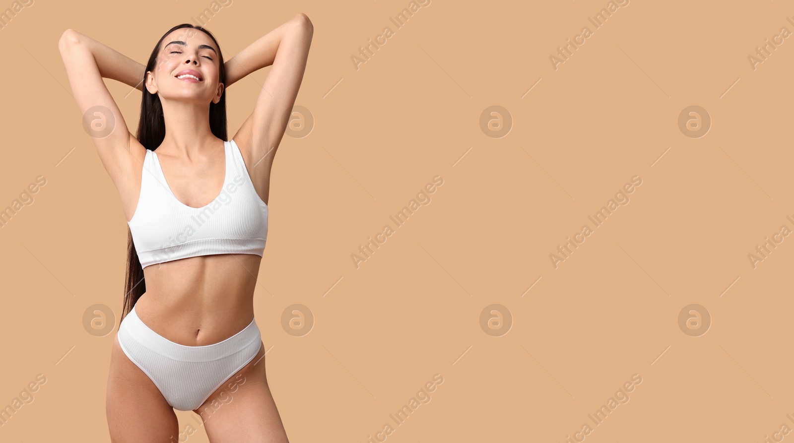 Image of Beautiful woman with smooth skin in underwear on dark beige background. Banner design with space for text. Body care