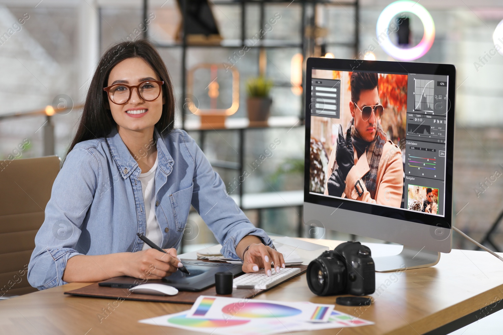 Photo of Professional retoucher working on computer in office