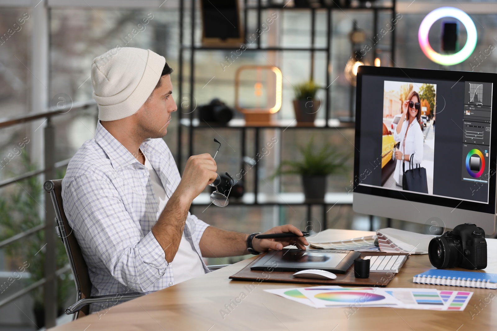 Photo of Professional retoucher working on computer in office