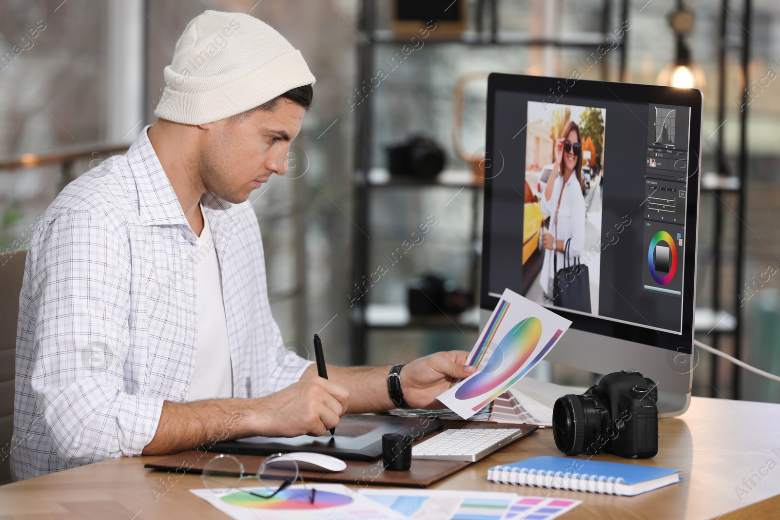 Photo of Professional retoucher working on computer in office