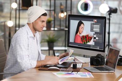 Professional retoucher working on computer in office