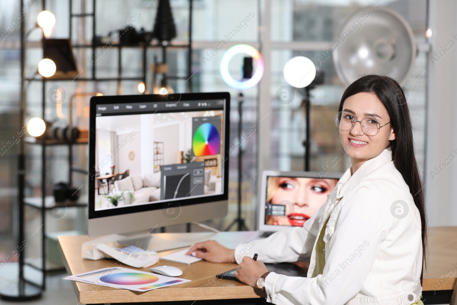 Photo of Professional retoucher working on computer in office