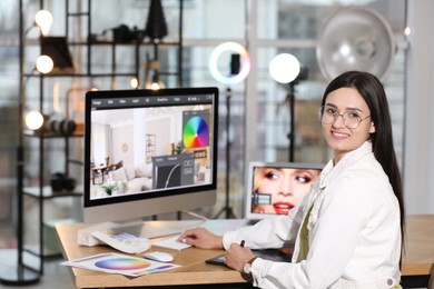 Professional retoucher working on computer in office