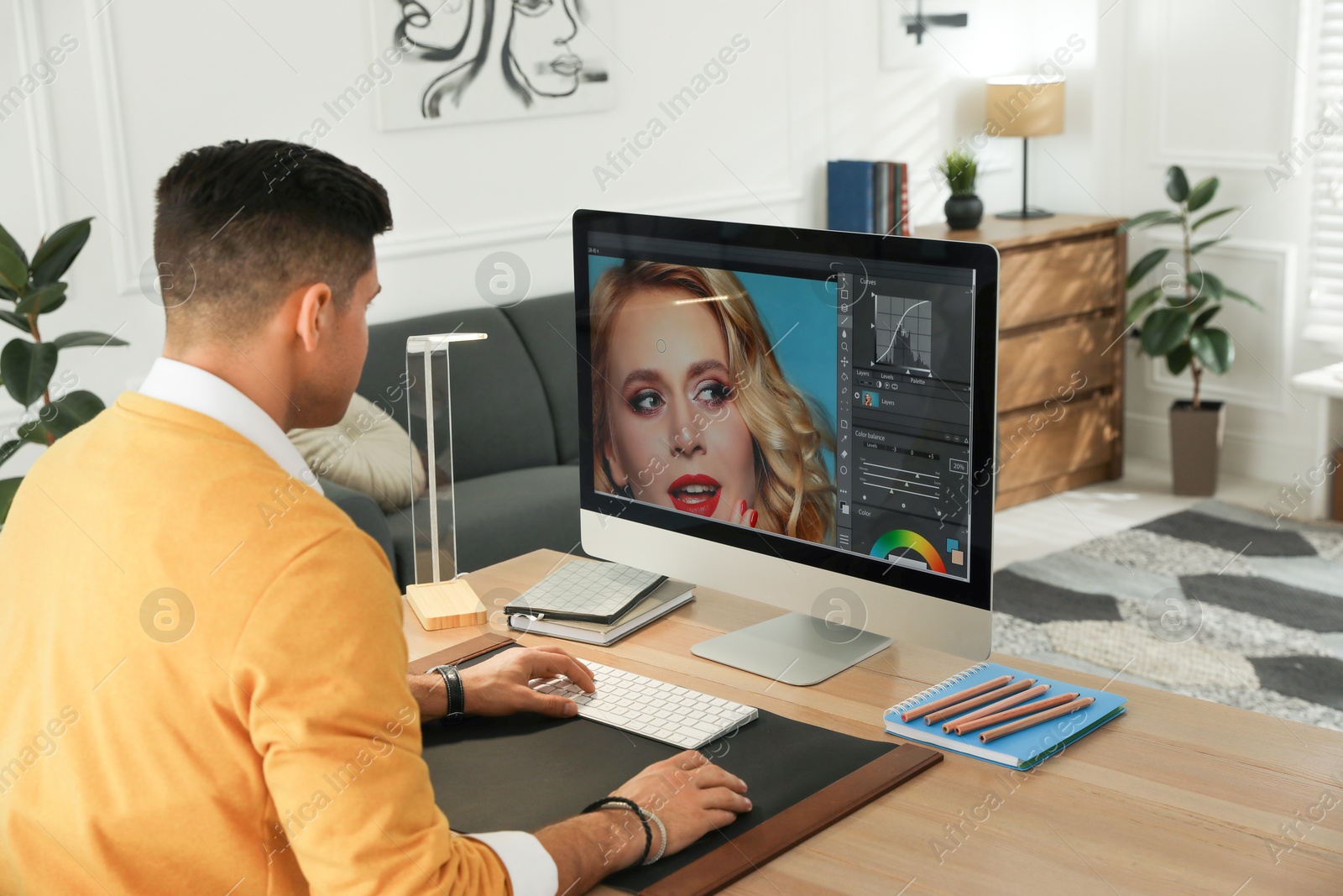 Photo of Professional retoucher working on computer in office