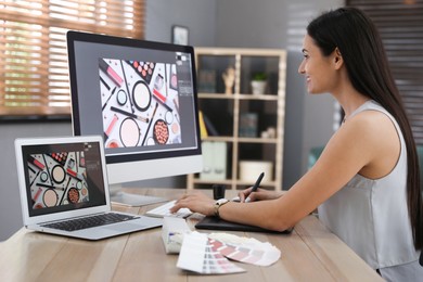 Photo of Professional retoucher working on computer in office