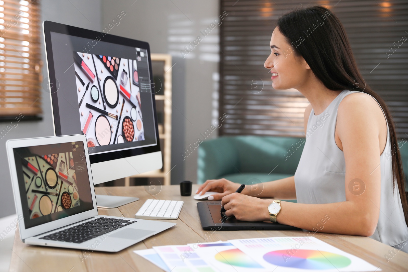 Photo of Professional retoucher working on computer in office