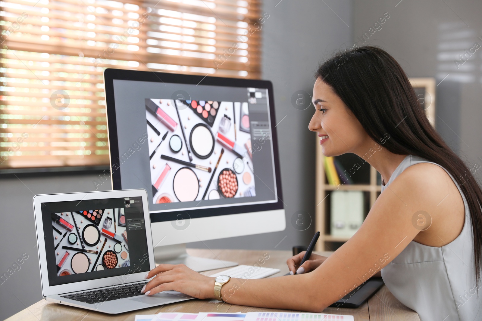 Photo of Professional retoucher working on computer in office