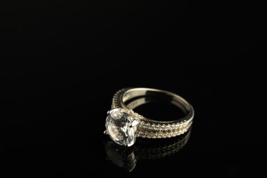 Beautiful bijouterie. Stylish ring on black background