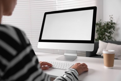 Photo of Woman working with computer monitor at table in office, closeup. Mockup for design