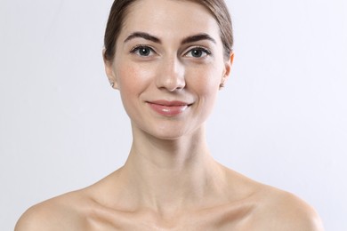 Photo of Beautiful young woman after henna eyebrows dyeing on light background, closeup