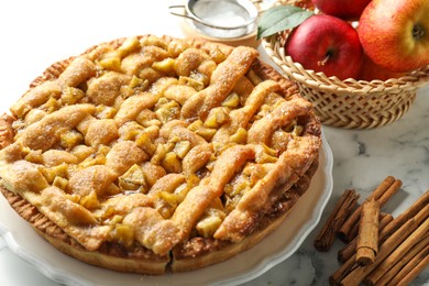 Photo of Homemade apple pie and ingredients on white marble table