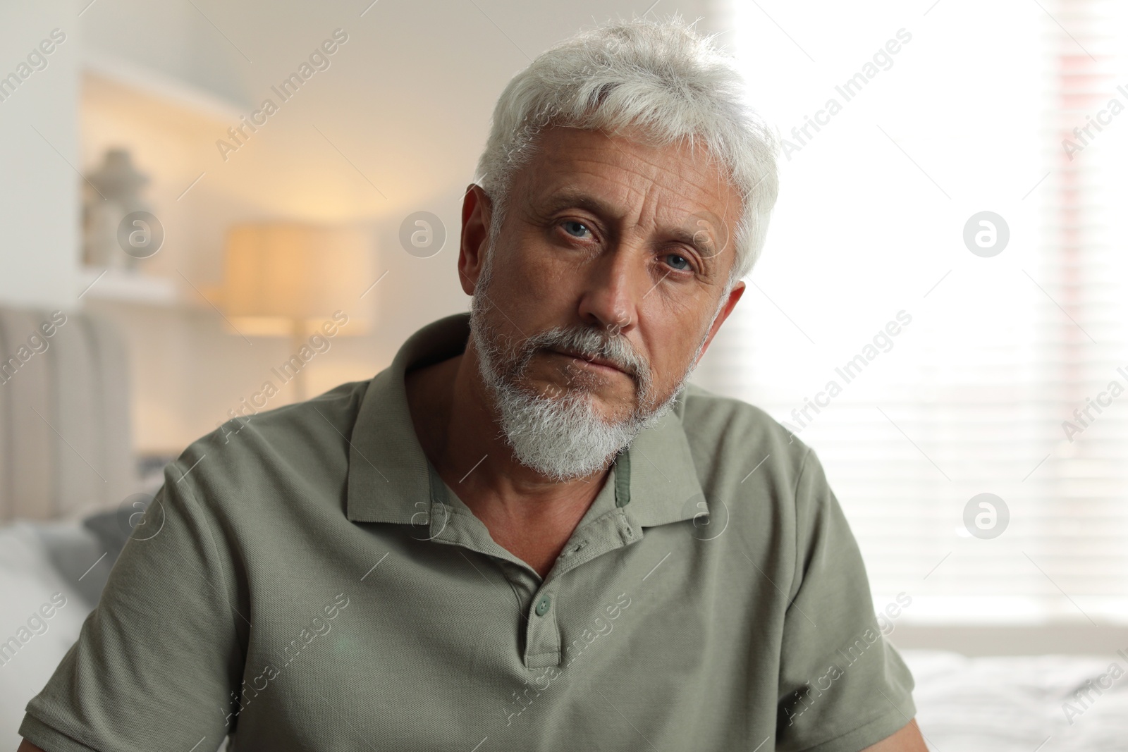 Photo of Portrait of lonely senior man at home