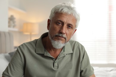 Photo of Portrait of lonely senior man at home