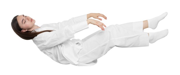 Photo of Young woman suffering from sleepwalking on chair against white background