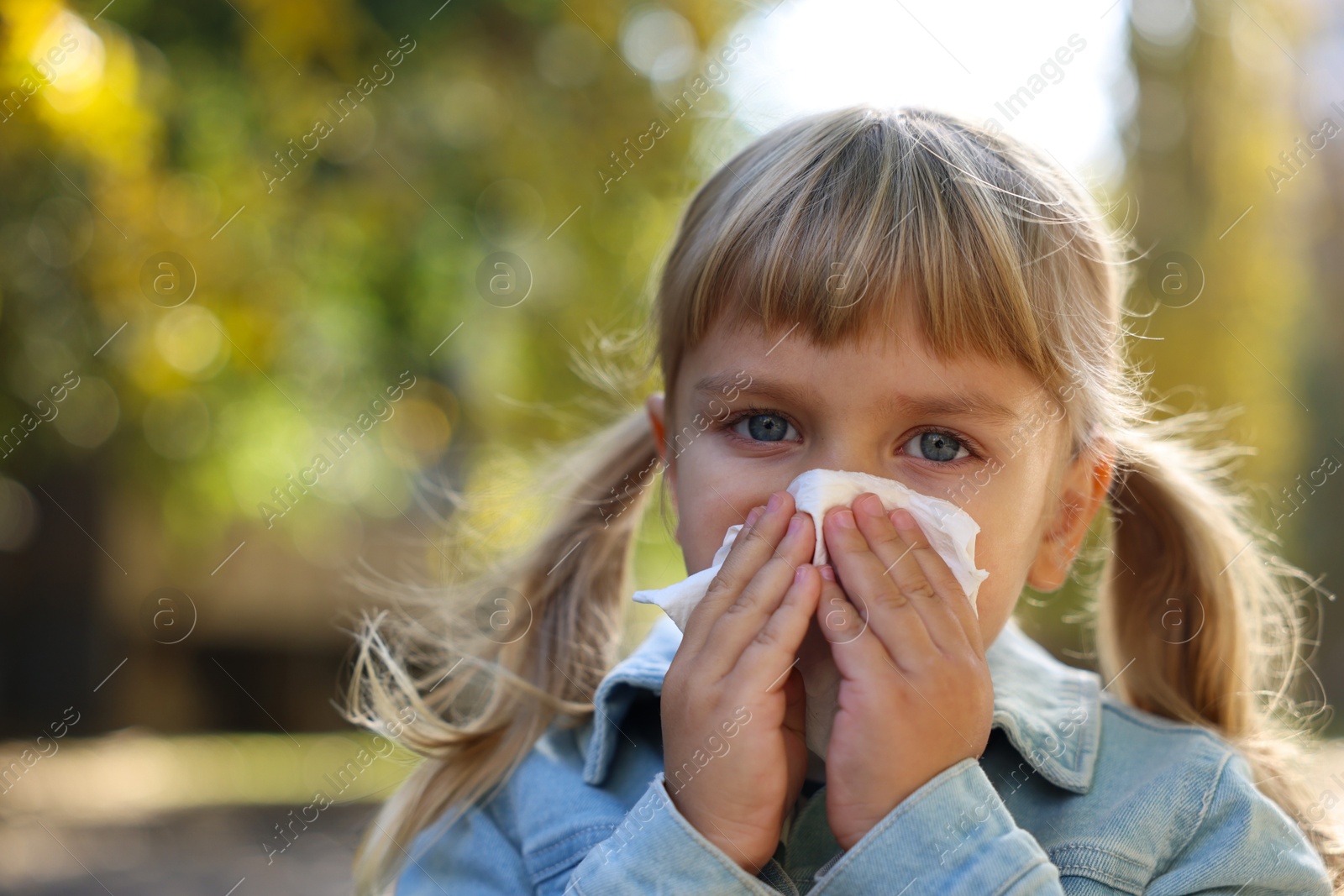 Photo of Little girl with runny nose in park