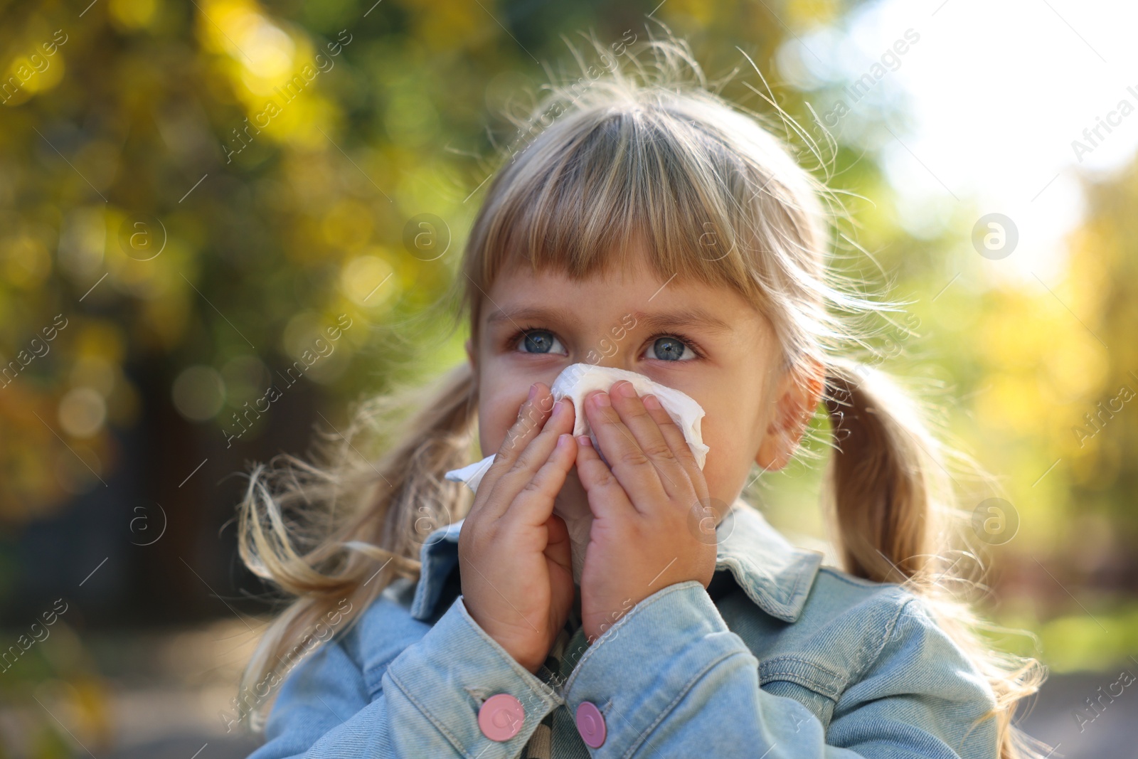 Photo of Little girl with runny nose in park