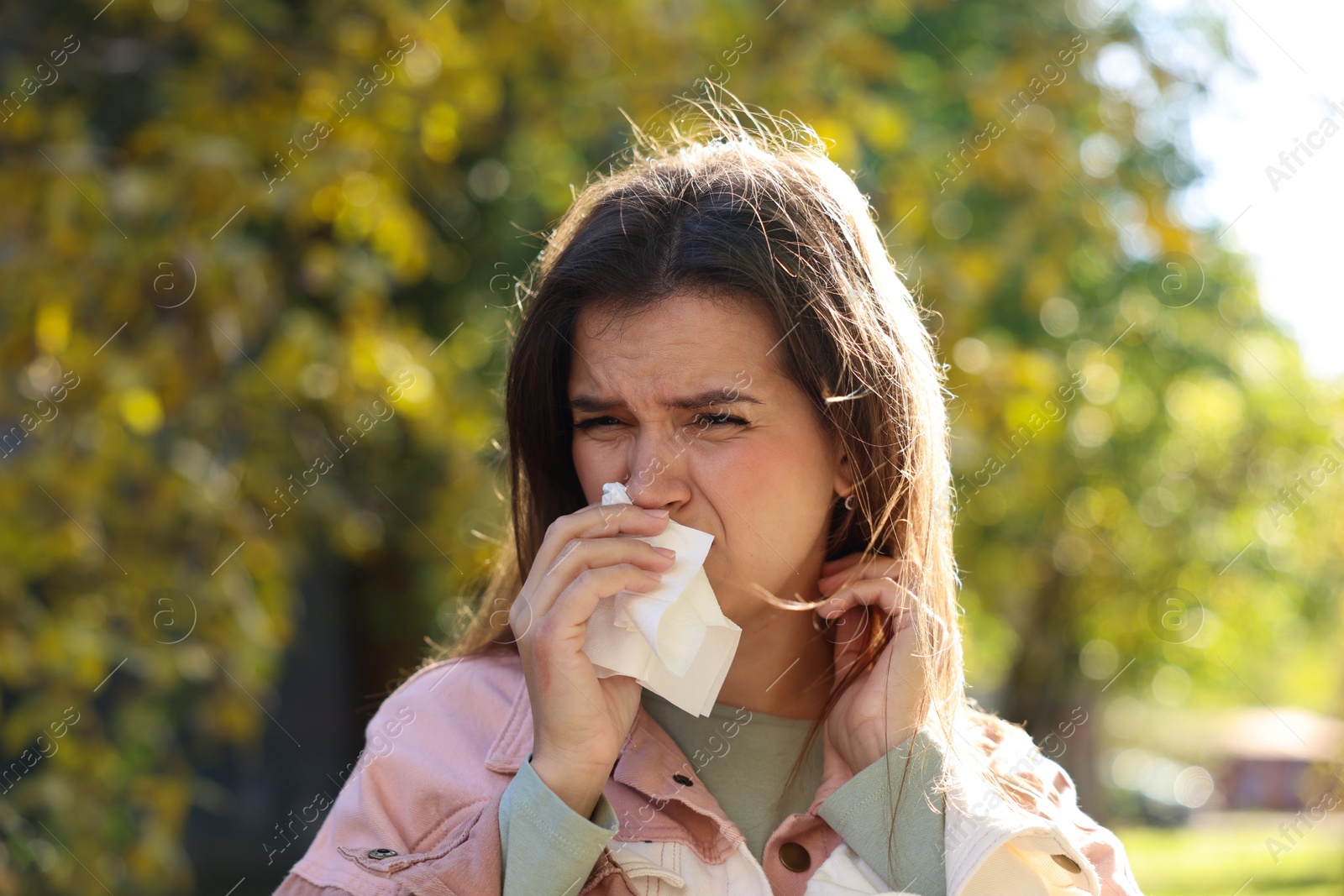 Photo of Young woman with runny nose in park