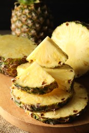 Photo of Slices of fresh ripe pineapples on table, closeup