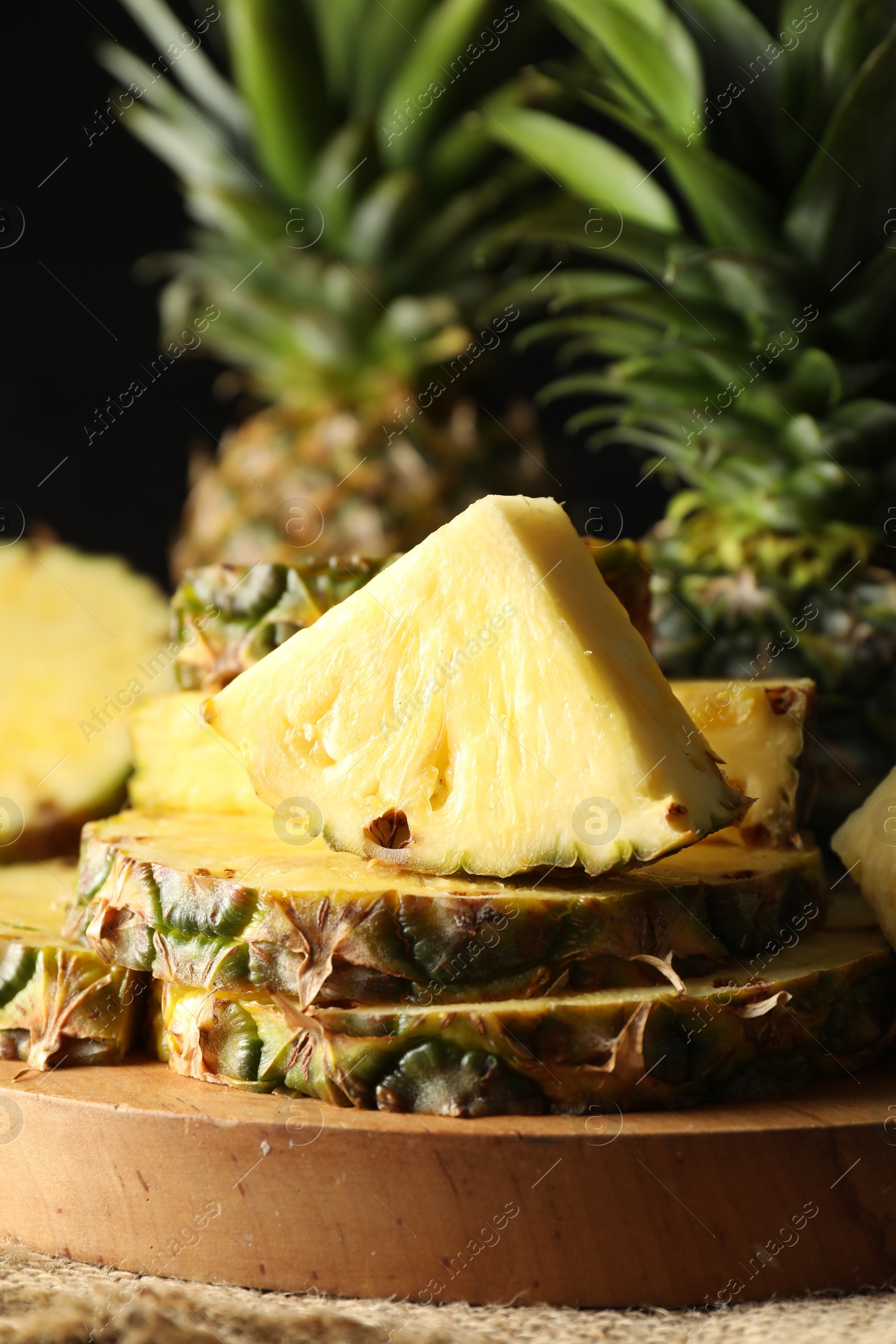 Photo of Slices of ripe pineapple on table, closeup