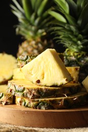 Slices of ripe pineapple on table, closeup