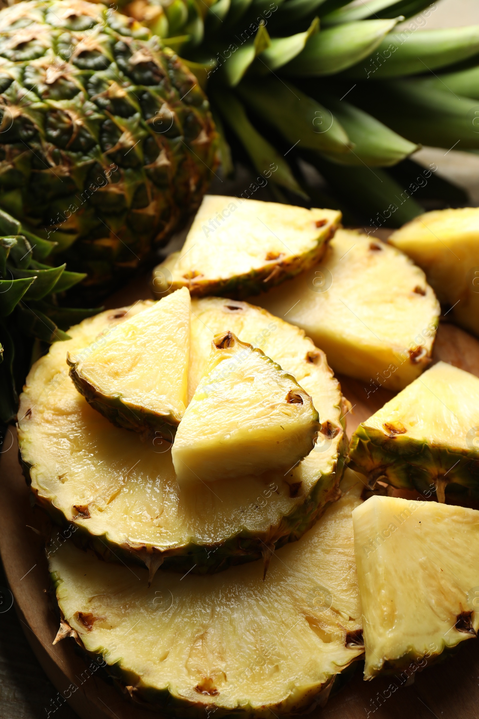 Photo of Slices of fresh ripe pineapple on table, closeup