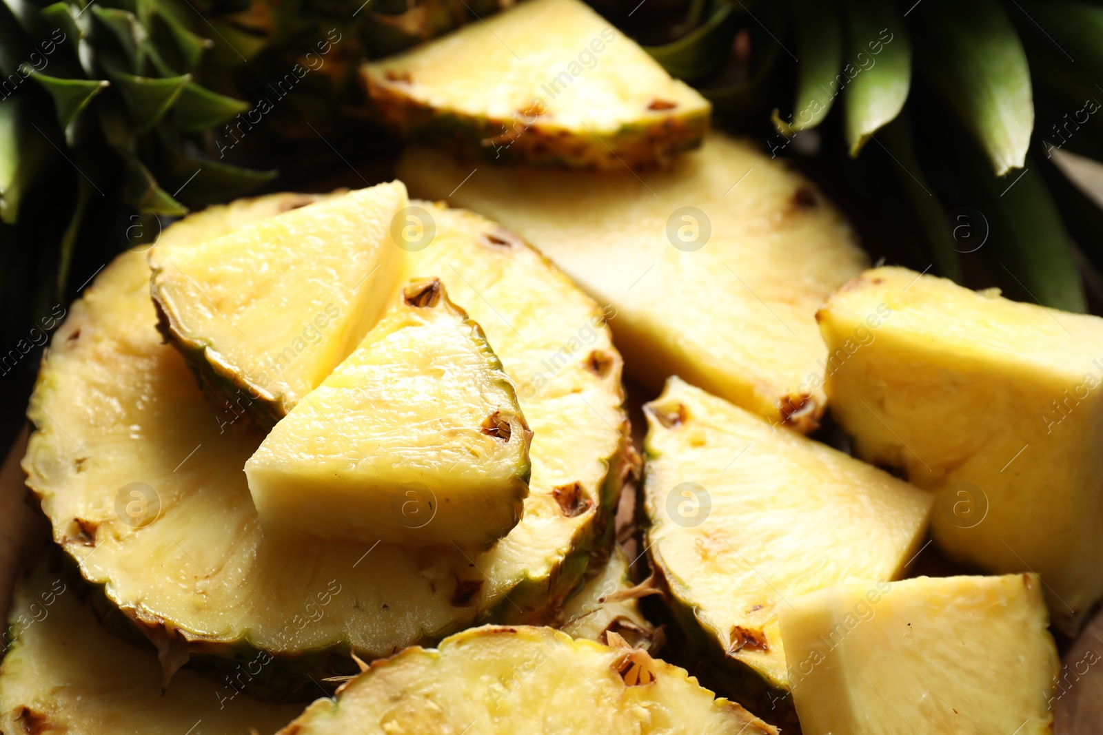 Photo of Slices of fresh ripe pineapple on table, closeup