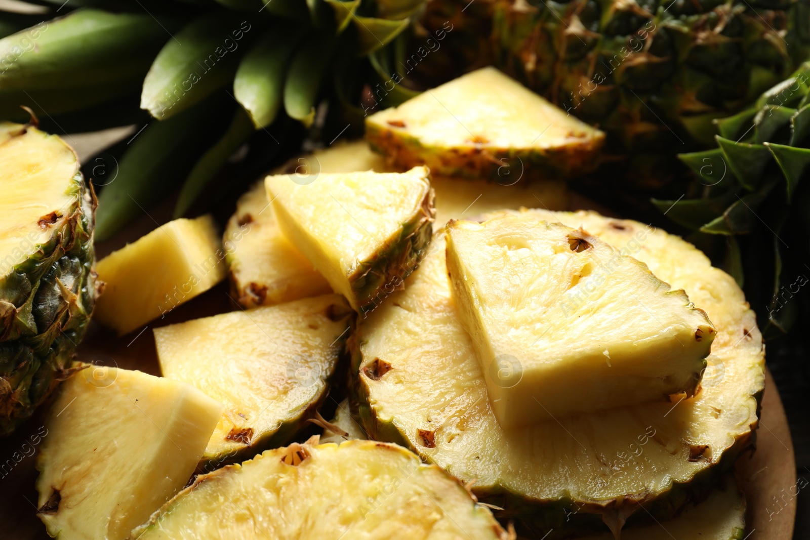 Photo of Slices of fresh ripe pineapple on table, closeup