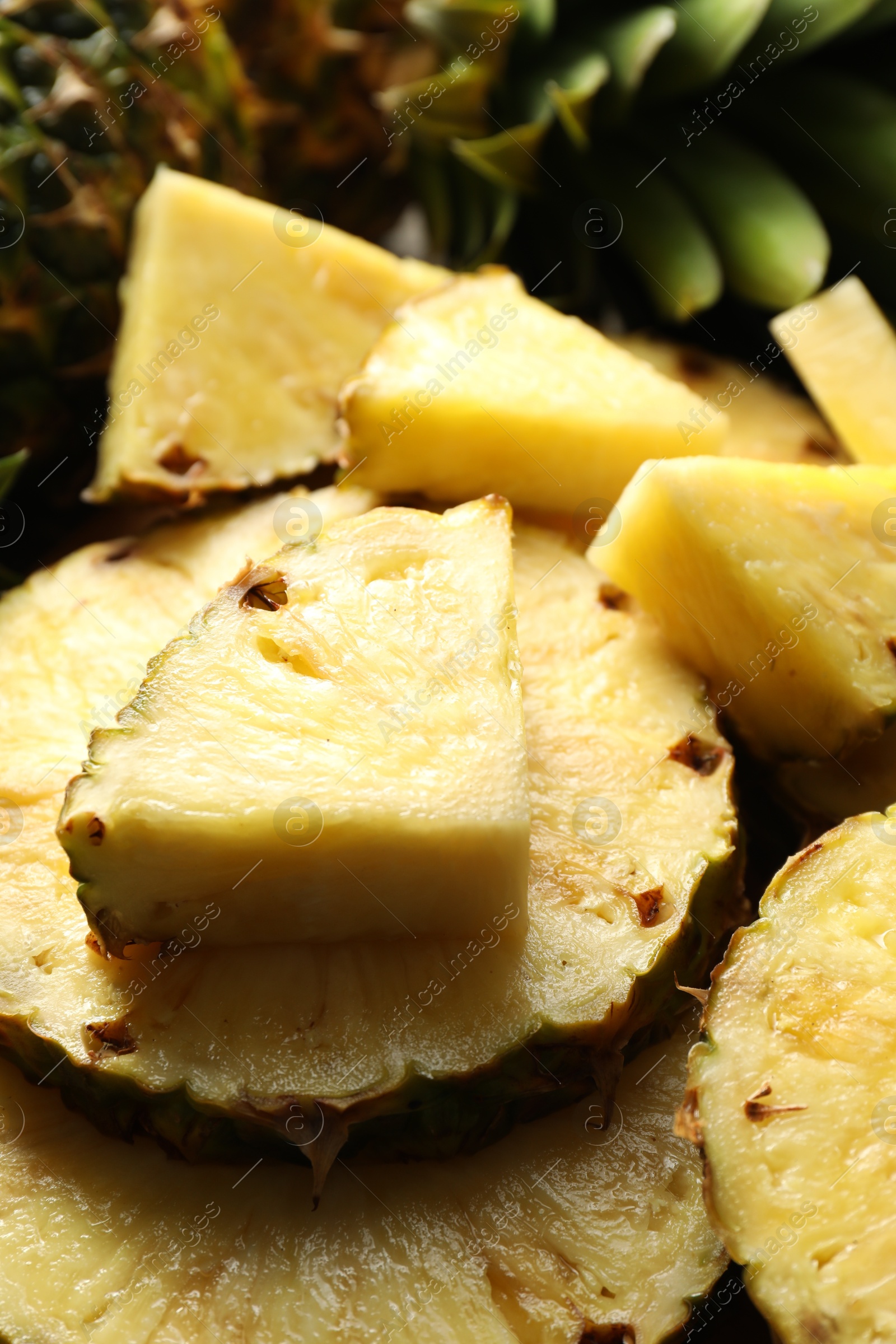 Photo of Slices of fresh ripe pineapple on table, closeup