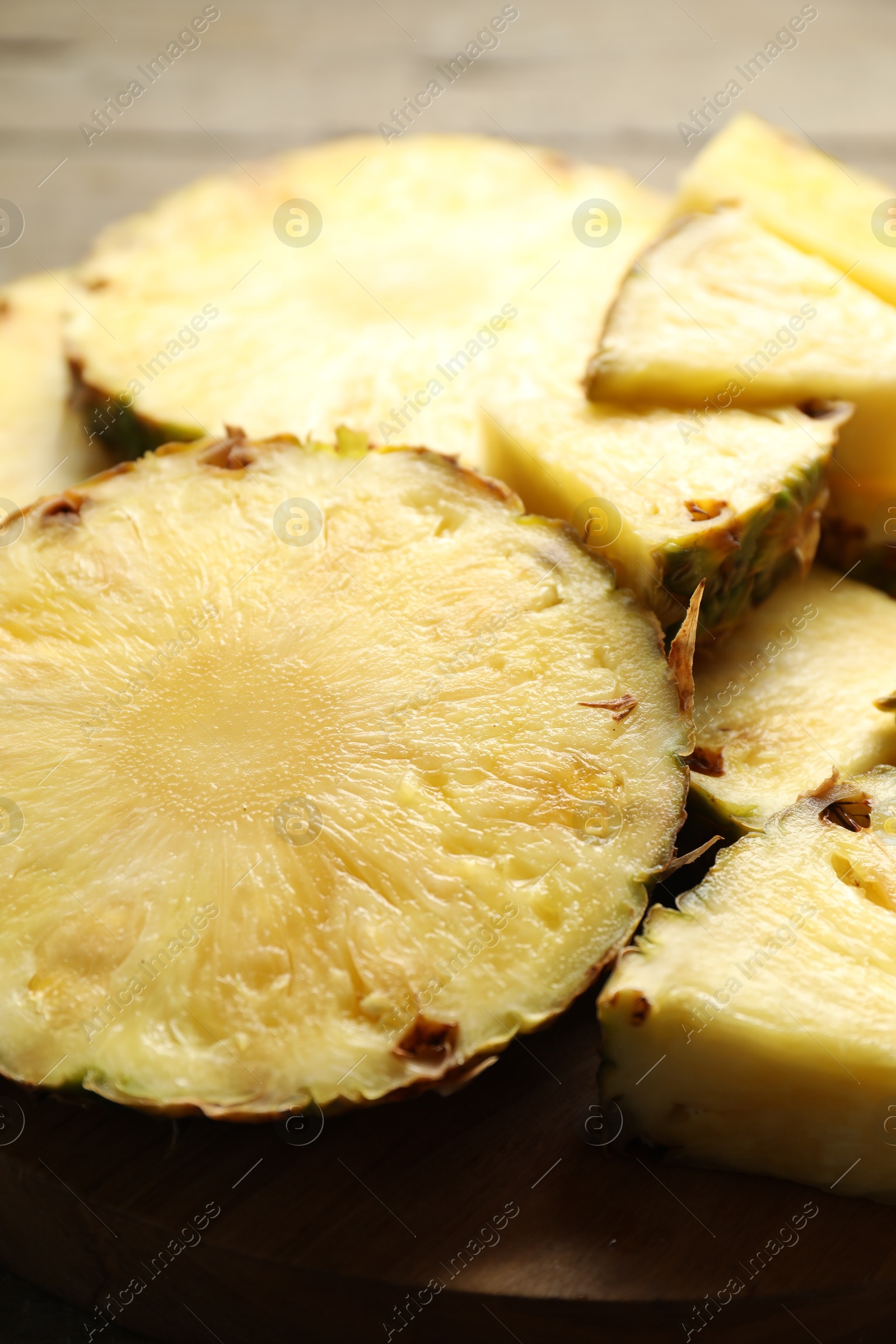 Photo of Slices of fresh ripe pineapple on table, closeup