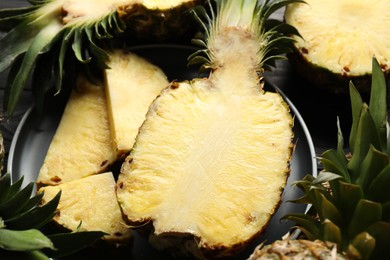 Cut fresh ripe pineapples on table, closeup