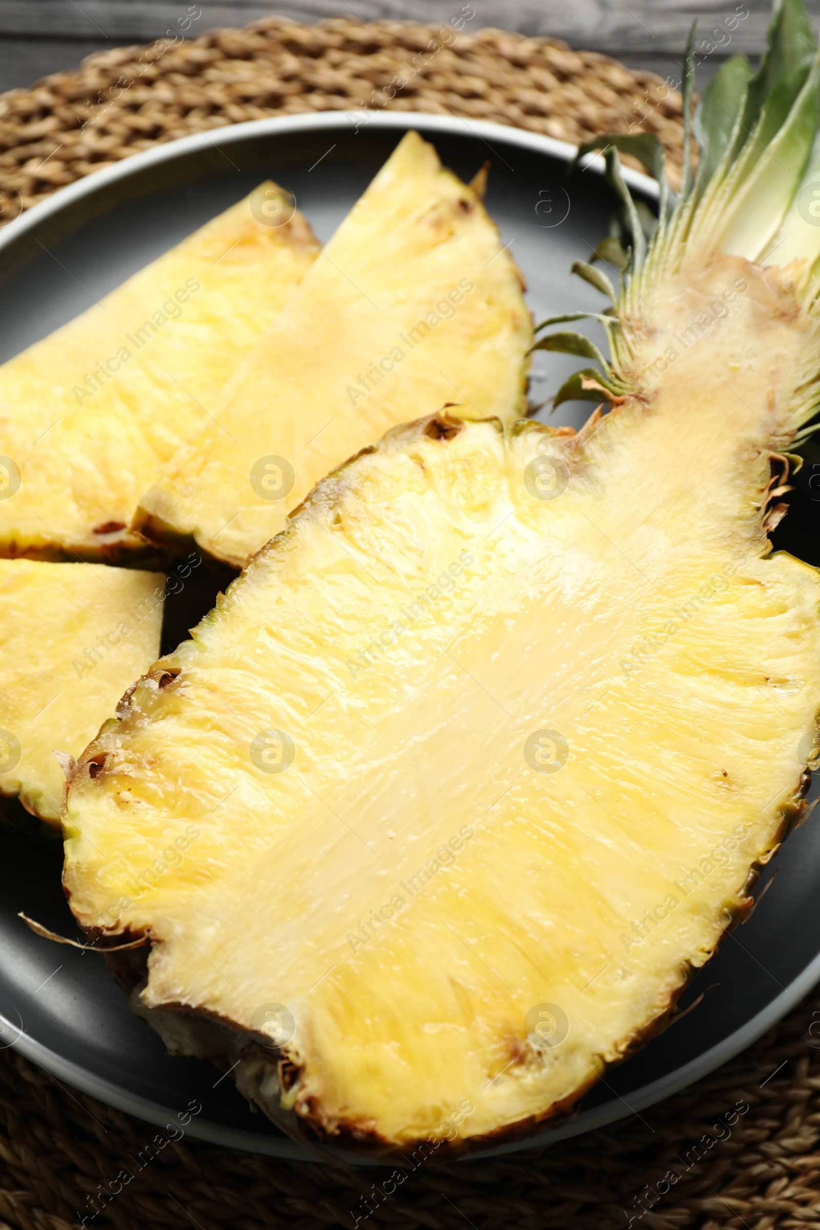 Photo of Cut fresh ripe pineapple on table, closeup