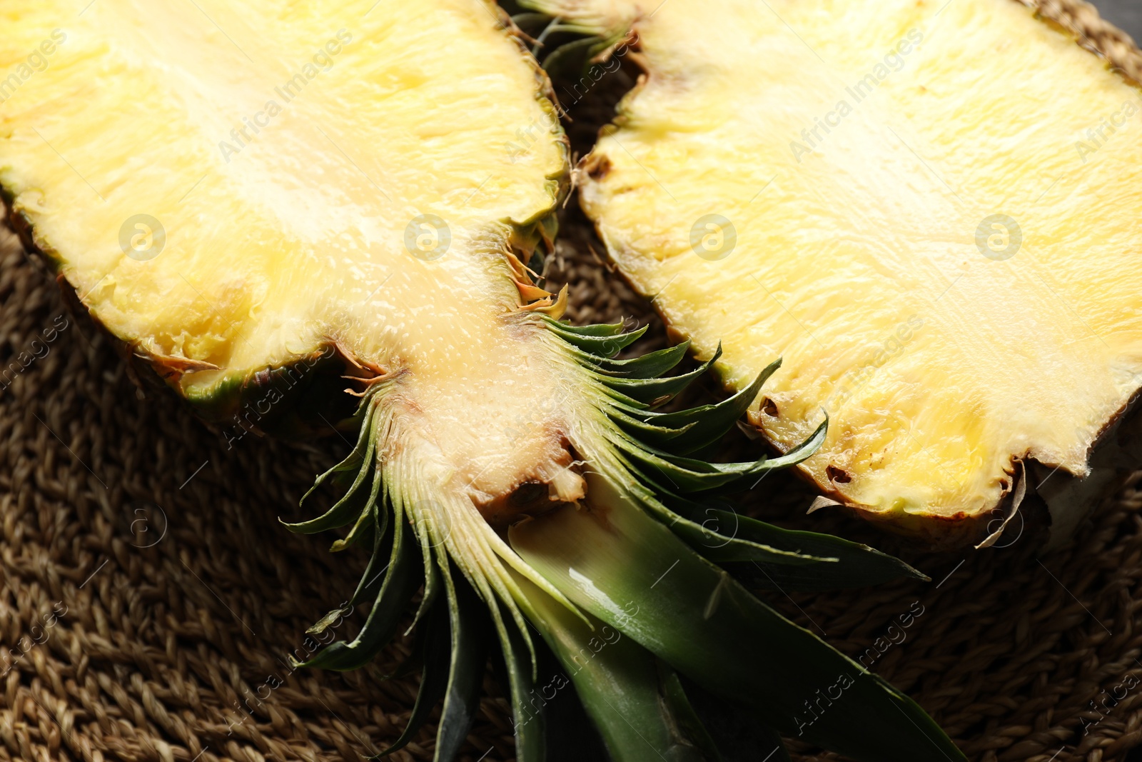 Photo of Halves of ripe pineapple on table, above view